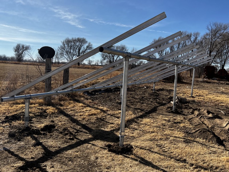 Ground-mount solar racking frame supported on helical piles