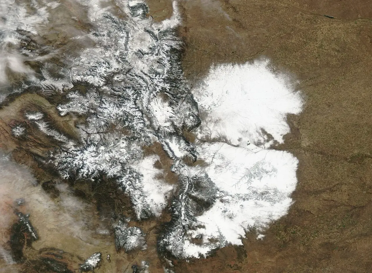 Satellite image of snow covering eastern Colorado and the Rocky Mountains after a November 2024 storm